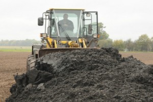 Tractor moving biosolids